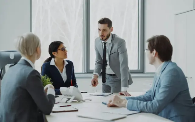 Business professionals in a meeting around a table