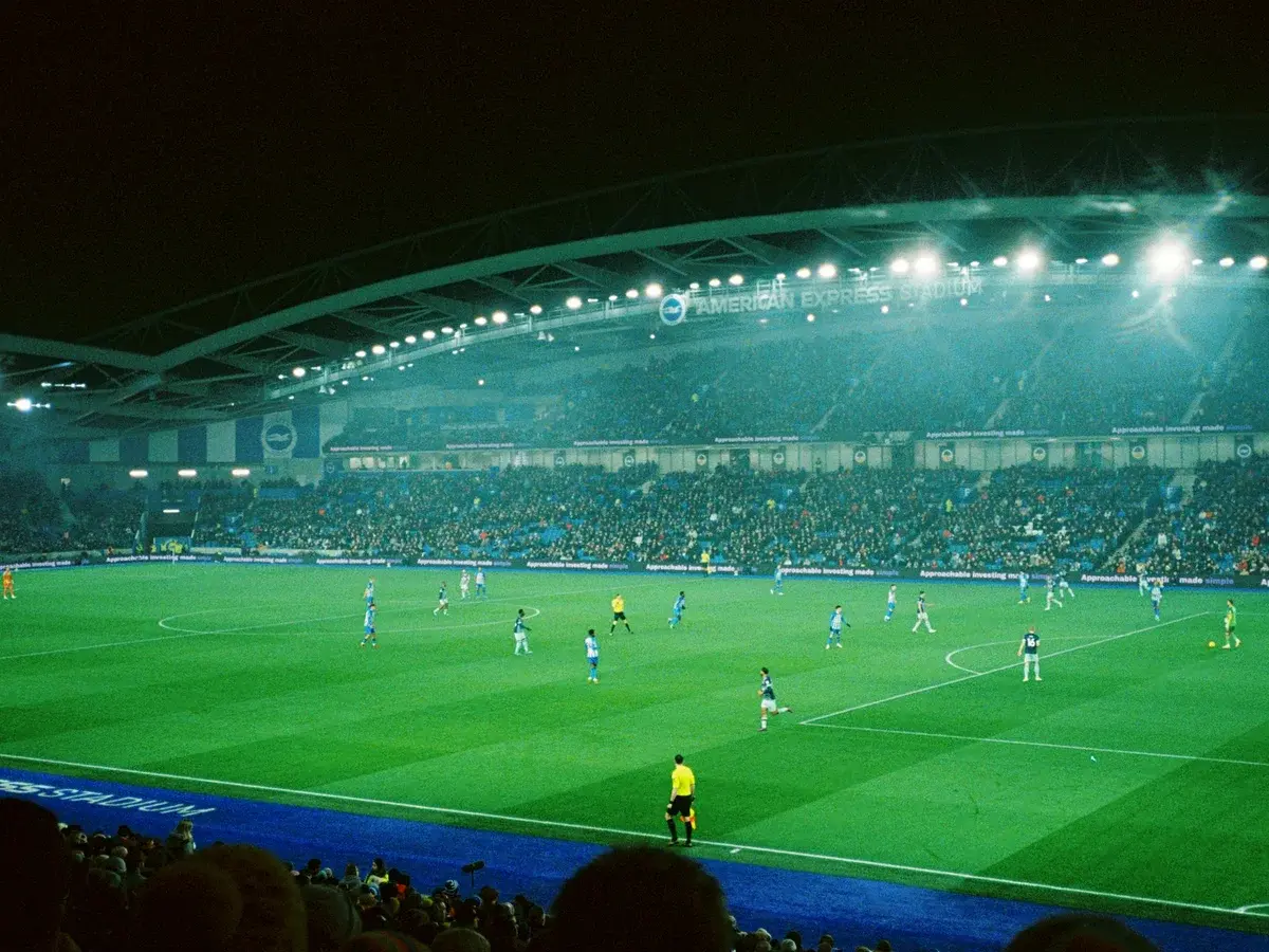 Floodlit football stadium during a night match