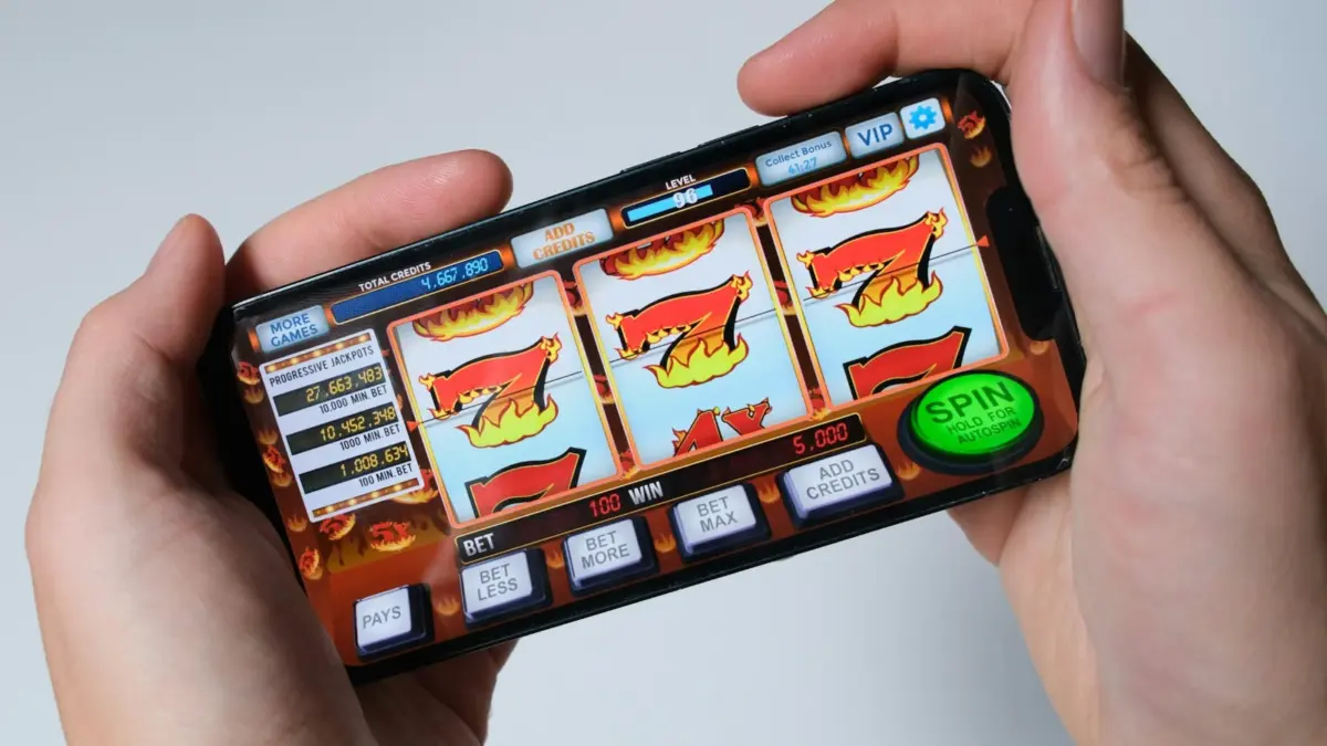 Player spinning a slot game on a smartphone