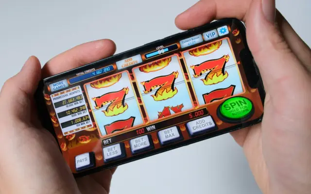 Player spinning a slot game on a smartphone