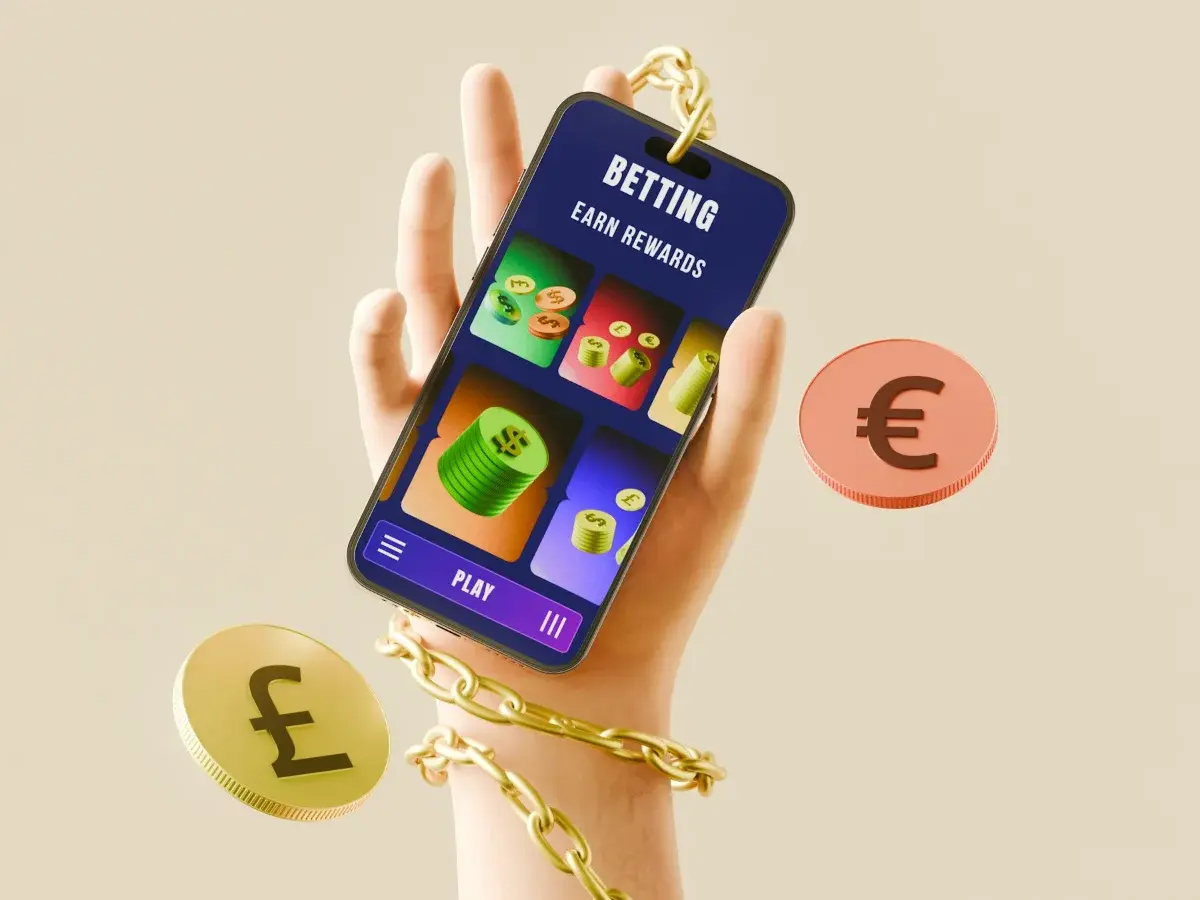 Hand holding a smartphone showing a gambling app