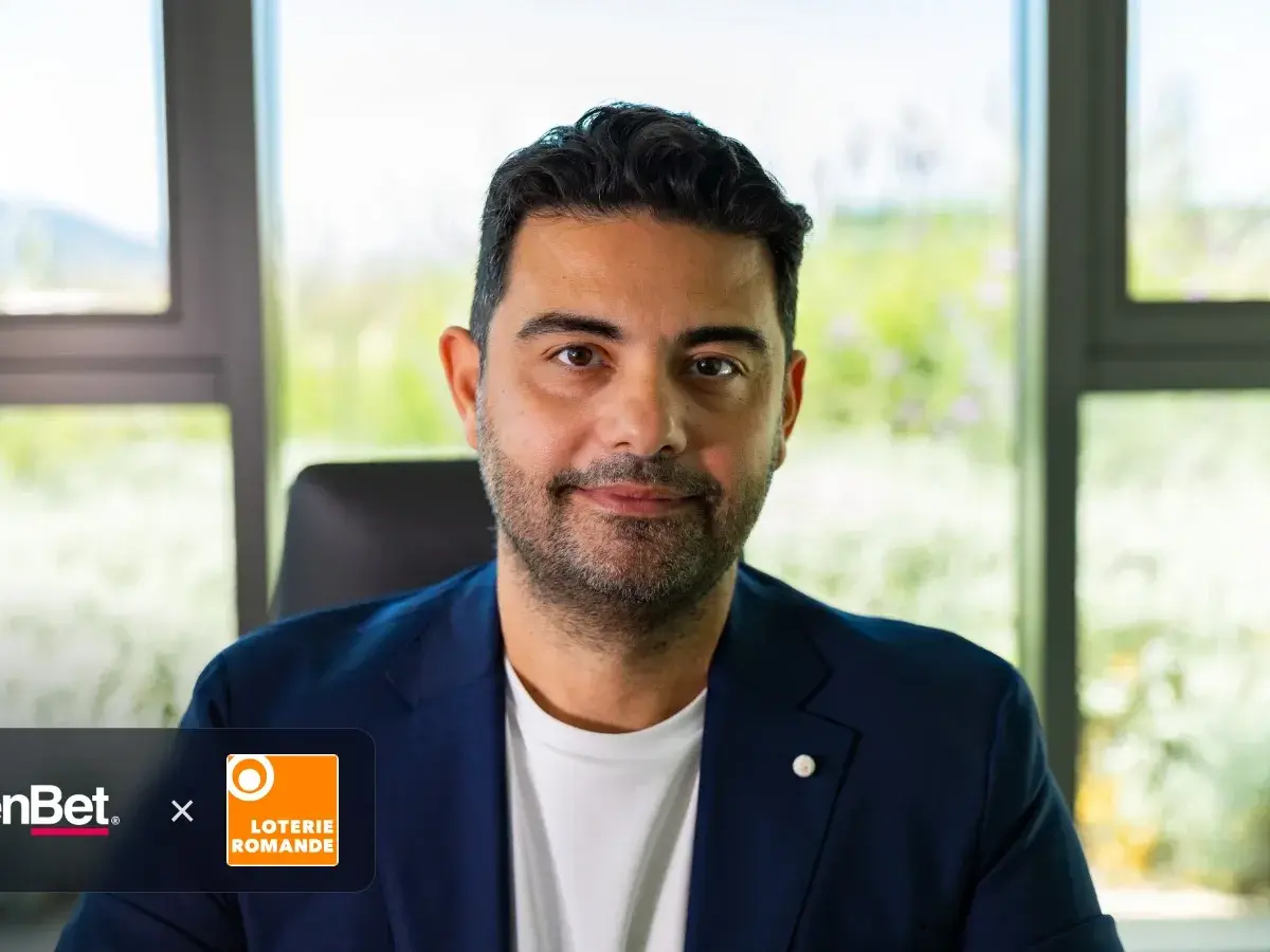 Nikos Konstakis, President at OpenBet, with OpenBet and Loterie Romande logos