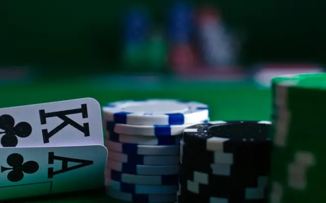Playing cards and poker chips on a green felt table