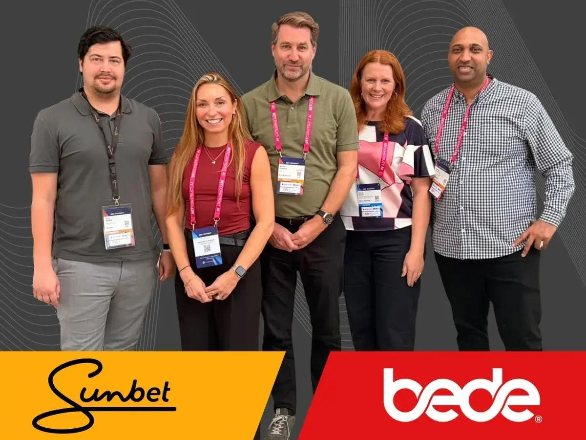 Sunbet and Bede Gaming teams at SBC Summit with both company logos